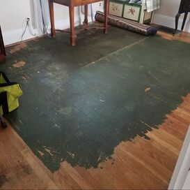 Old wood floor with green residue; before refinishing