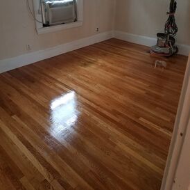 Wood floor after sanding and refinishing with shiny sealant